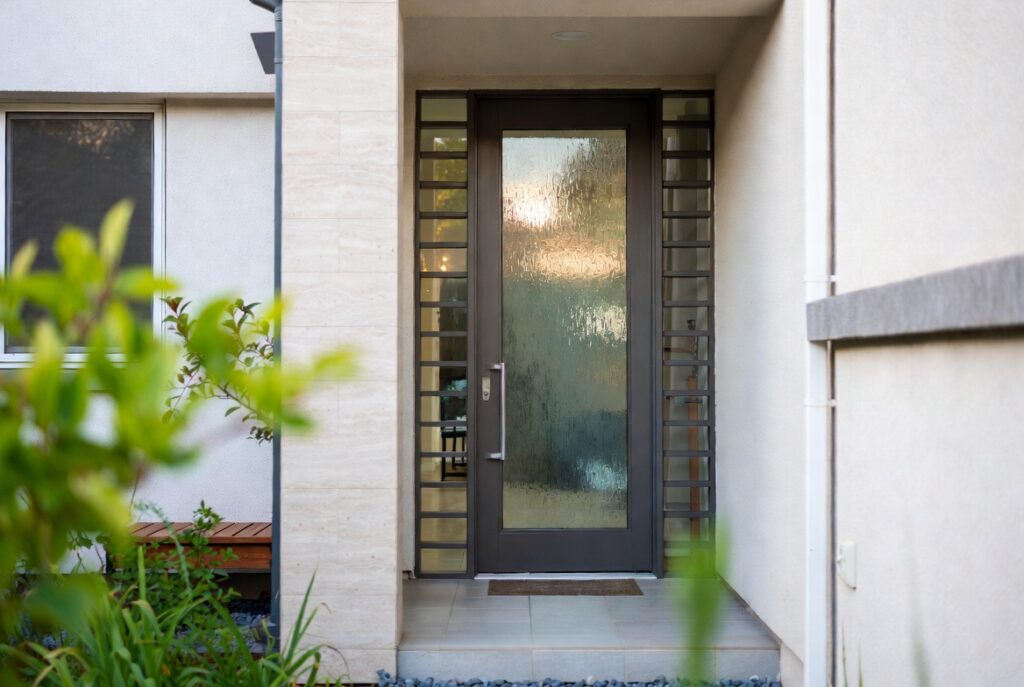 Front door with frosted glass panel inserts adding light and privacy