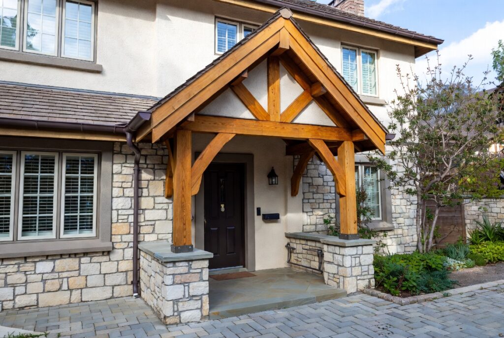 Covered entry with timber canopy adding architectural depth above front door