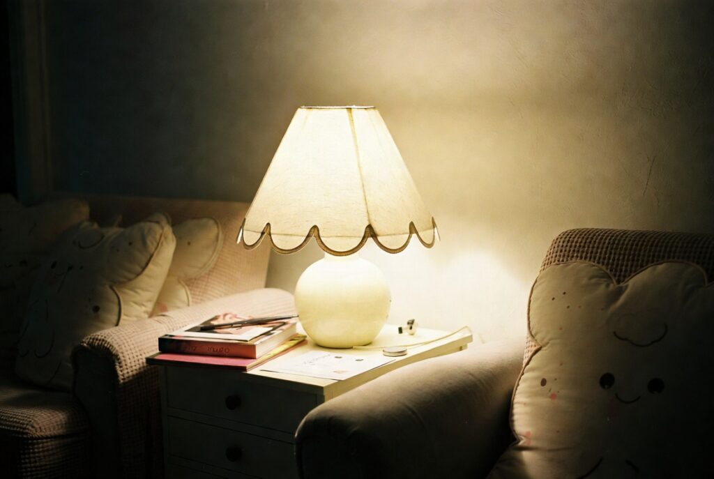 Charming room with scalloped-edge lampshade and scalloped cushions adding playful spring character, soft light