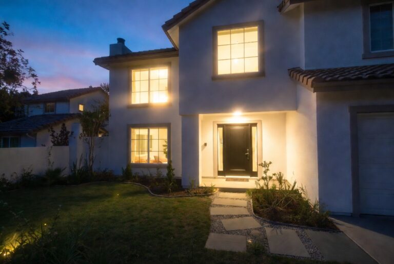Stunning home exterior with bold front door manicured lawn and elegant pathway lighting