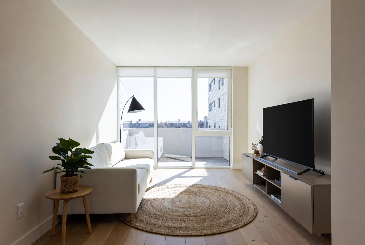 Bright modern living room with large windows neutral furniture and stylish decor accents