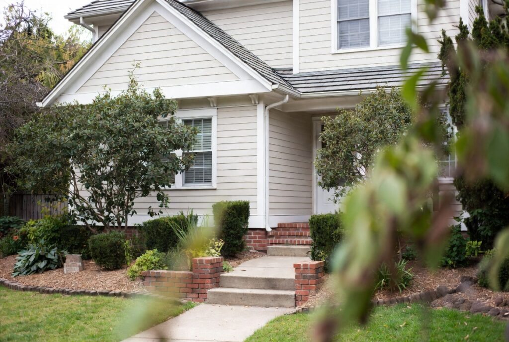 Freshly power washed home exterior siding and walkway looking well maintained