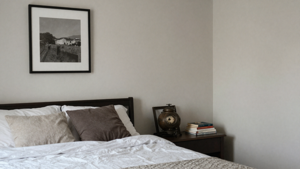 Alt Text: Personal bedroom styled with meaningful art and books giving the space soul and character