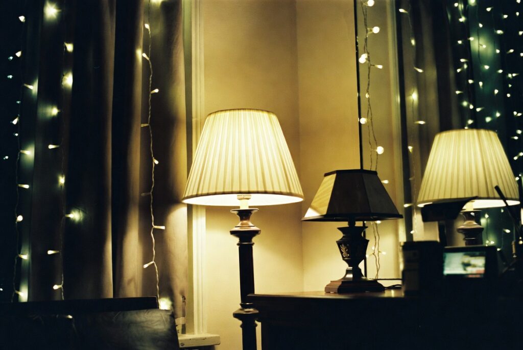 Cozy room lit by two warm-toned table lamps creating soft ambient glow, evening mood, candid shot