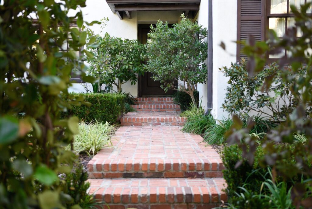 Classic brick walkway leading to front door with timeless texture