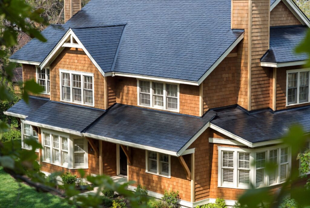 Dark charcoal architectural shingles paired with warm contemporary siding