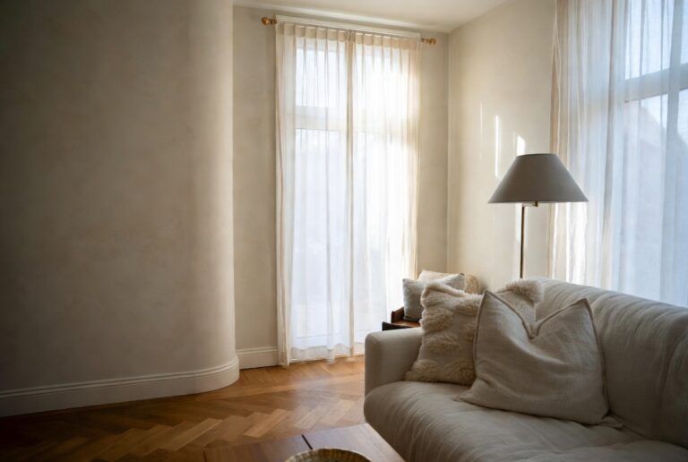 Elegant living room with warm herringbone oak floor limewash walls and soft natural lighting