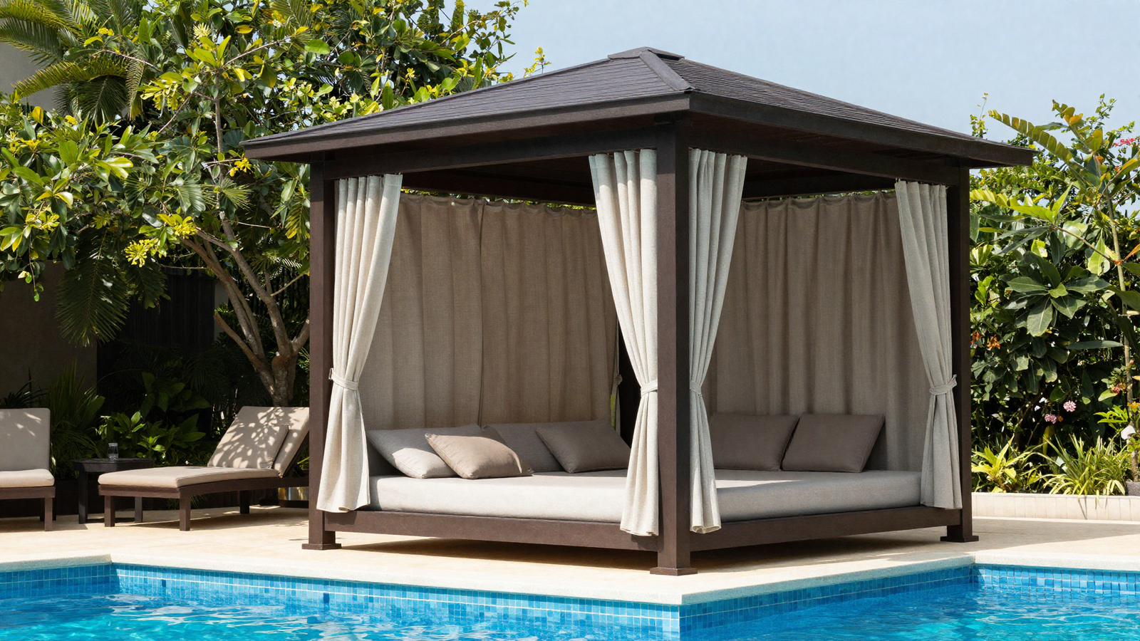 Poolside cabana structure with fabric curtains and plush lounge seating