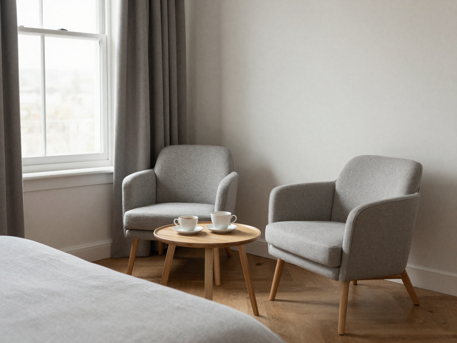 Small bedroom coffee corner with chairs near a window