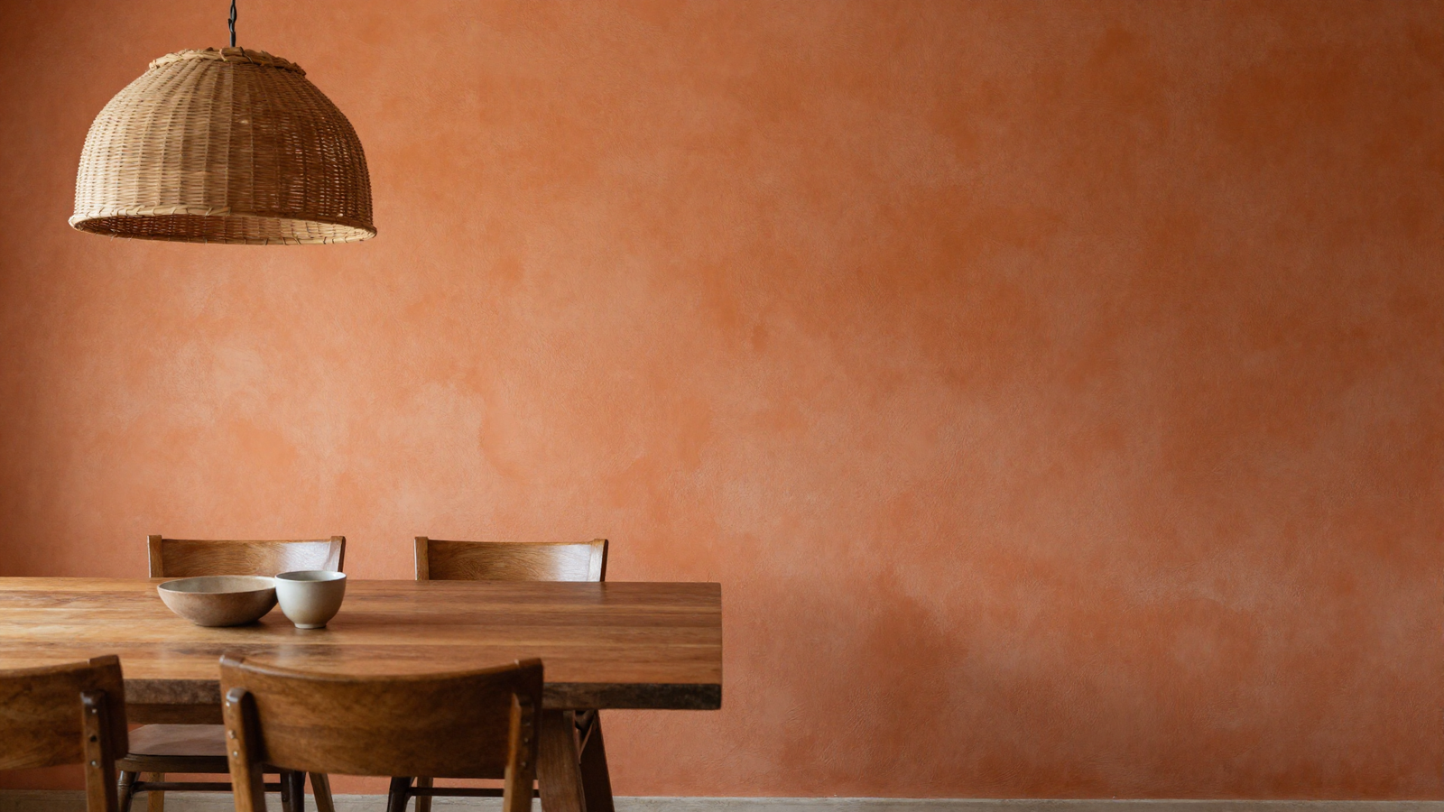 Dining room wall with terracotta orange limewash textured paint finish