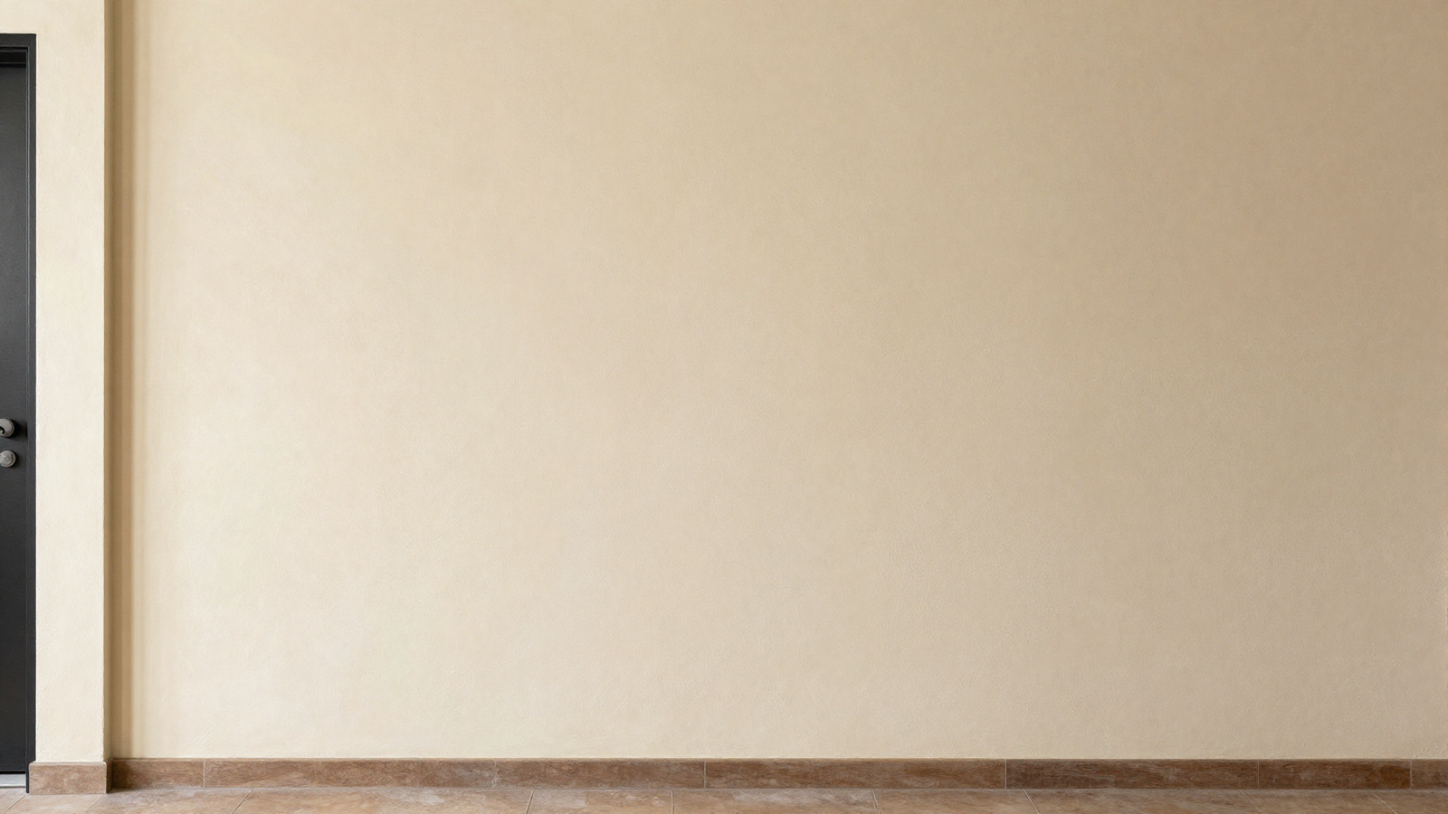 Entryway wall with hand-applied textured plaster finish in soft cream tone