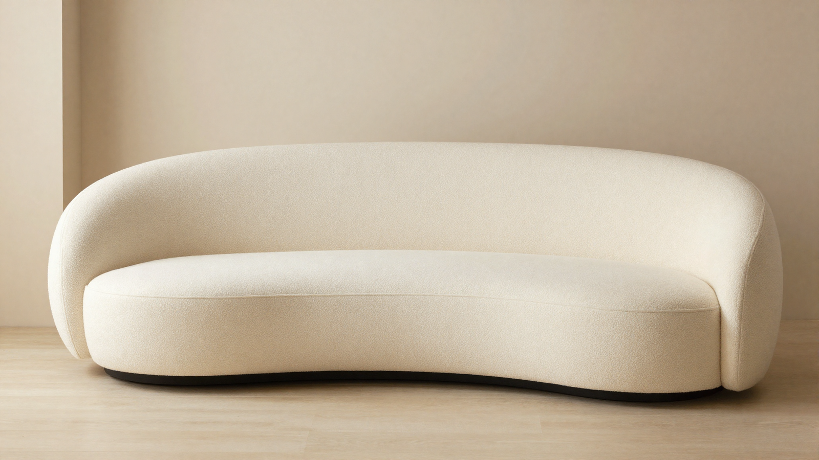 Living room with curved sculptural sofa in cream boucle fabric and rounded organic shape