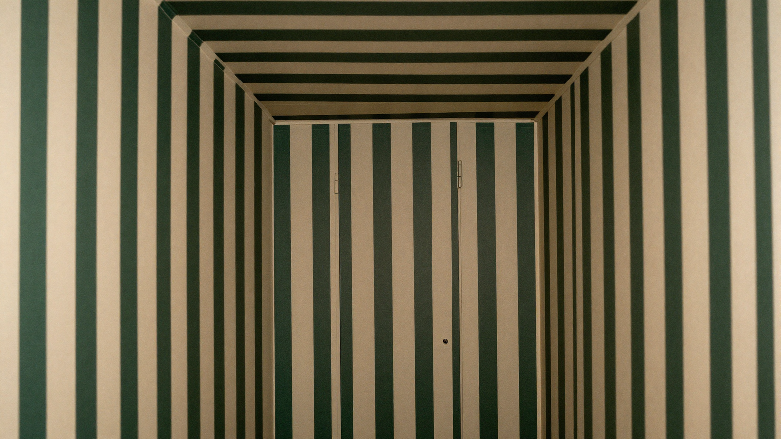 Small powder room with fine narrow stripe wallpaper wrapped from wall onto ceiling in deep green and cream