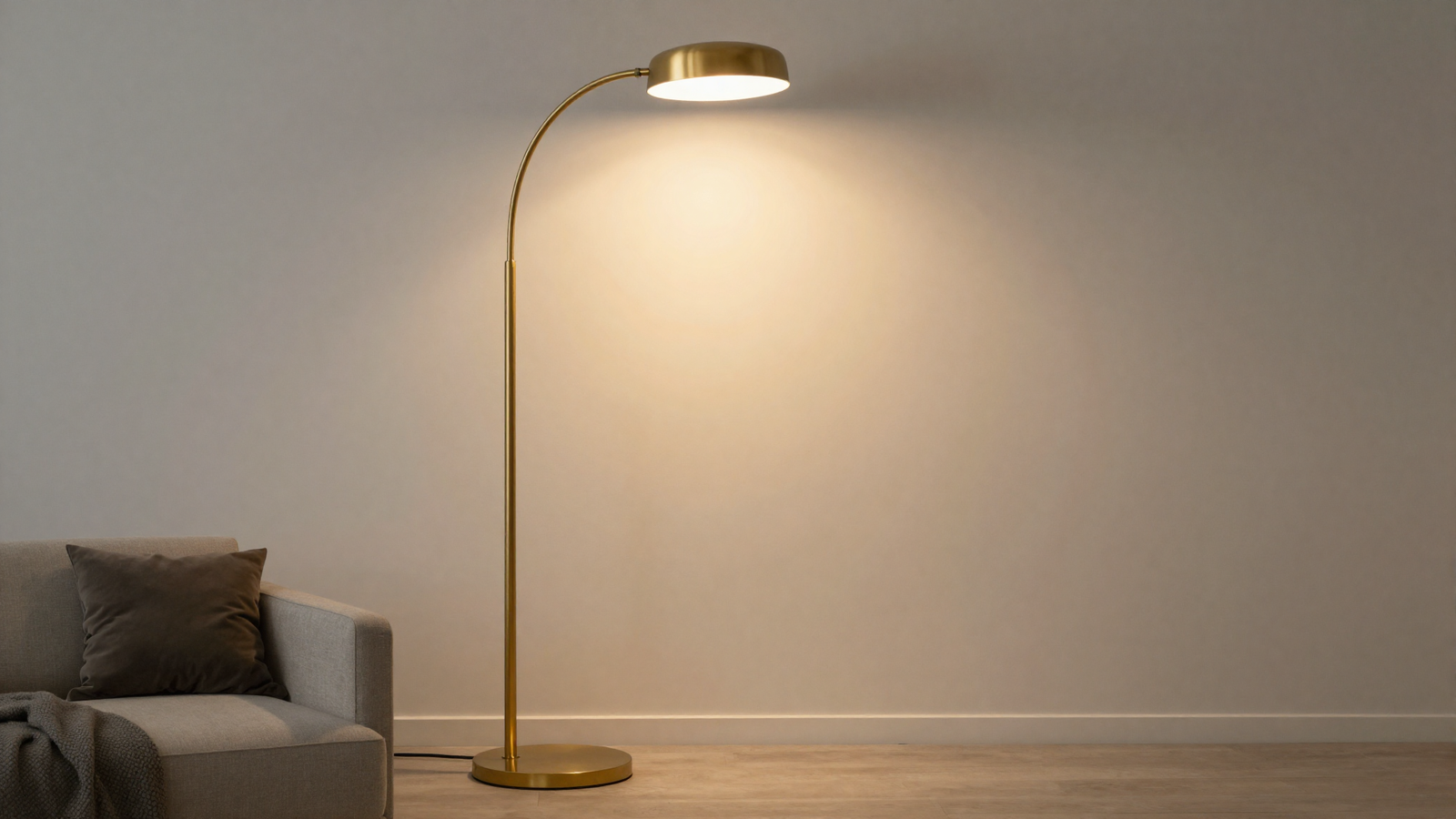 Living room with sculptural curved floor lamp in warm brass finish