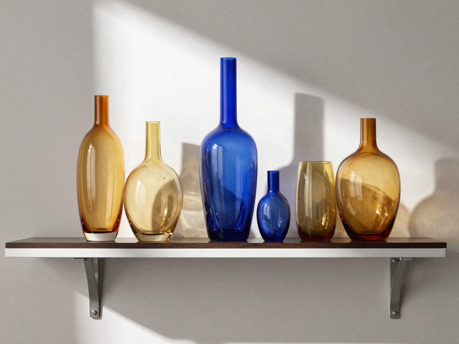 Amber and cobalt glass vases catching sunlight on a living room shelf