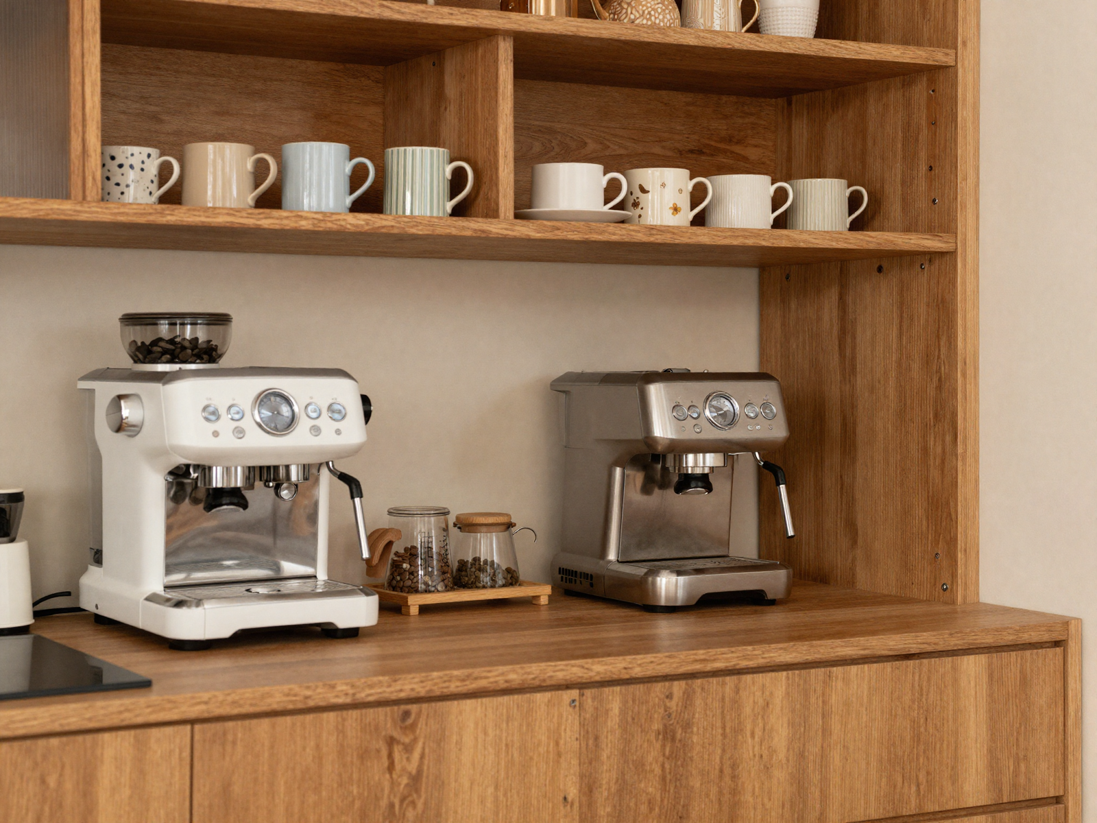 Kitchen coffee station with espresso machine and mugs on open shelf