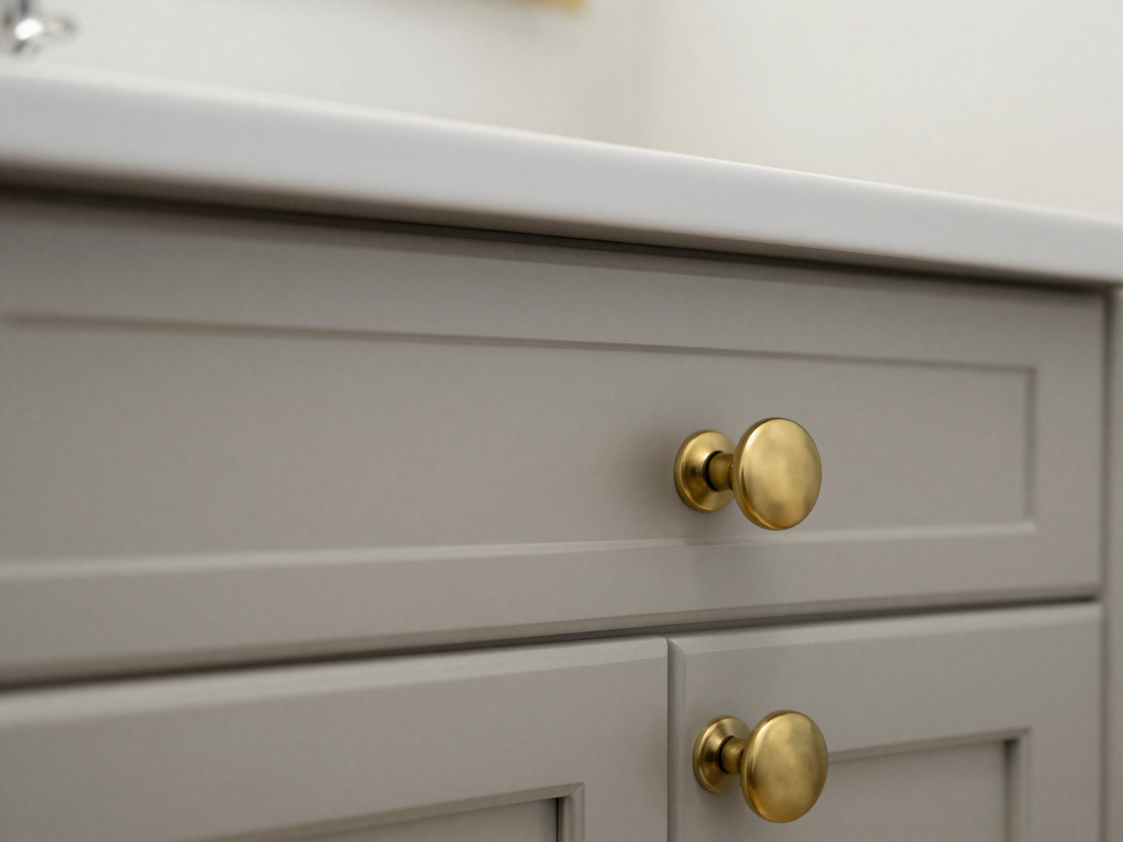 Bathroom vanity cabinet with new brass knobs and pulls