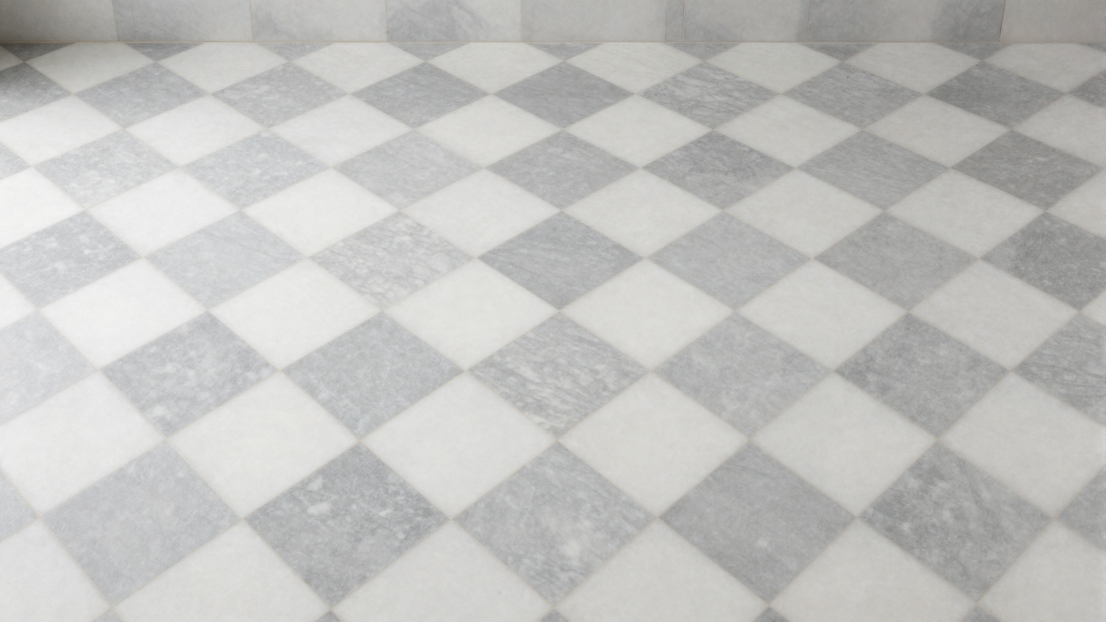 Bathroom floor with checkerboard marble tile pattern in soft Bardiglio gray and Carrara white