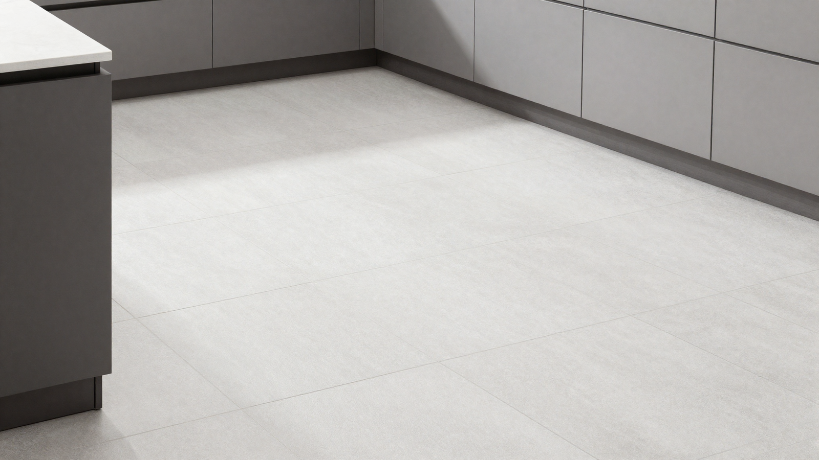 Kitchen floor with large-format light gray porcelain tile and minimal grout lines