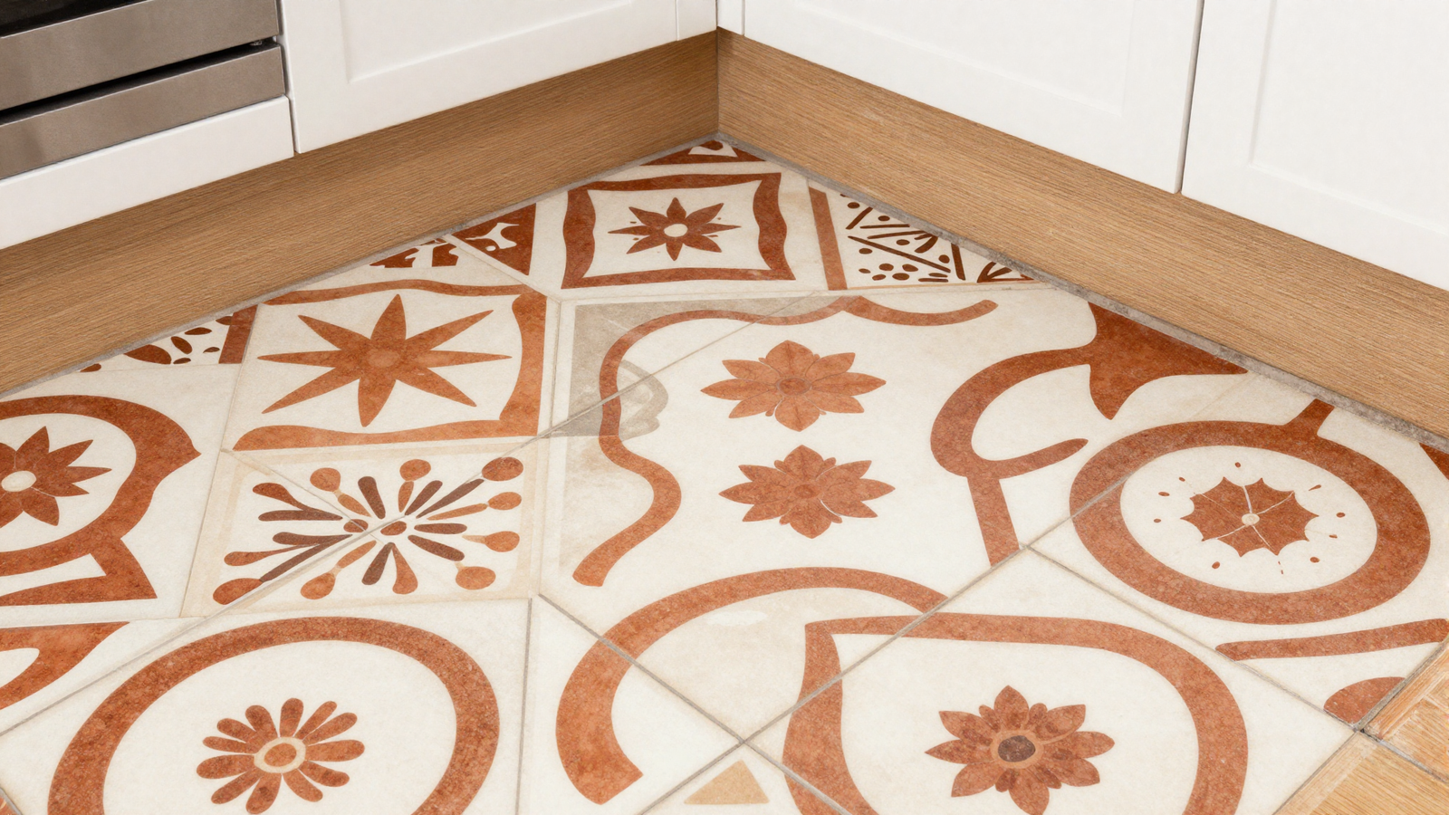 Kitchen floor with bold geometric porcelain tile featuring abstract floral motif in terracotta and cream