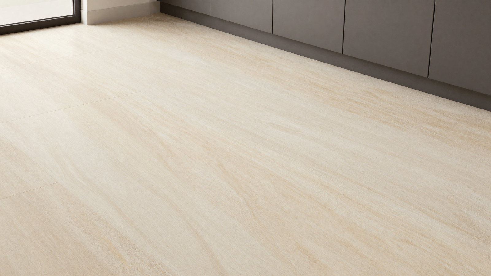 Kitchen floor with warm stone-look large tile in Taj Mahal quartzite pattern with soft veining