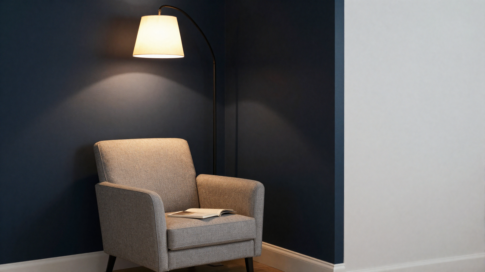 Reading nook with midnight blue almost-black accent wall and cozy armchair