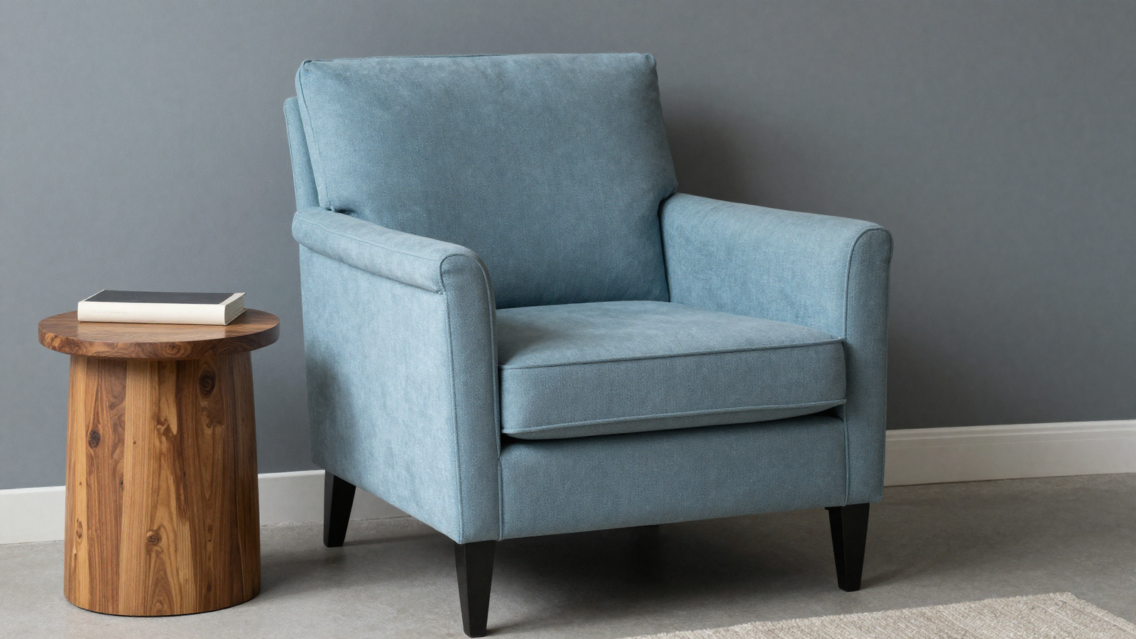 Living room with dusty blue accent armchair paired with warm wood side table
