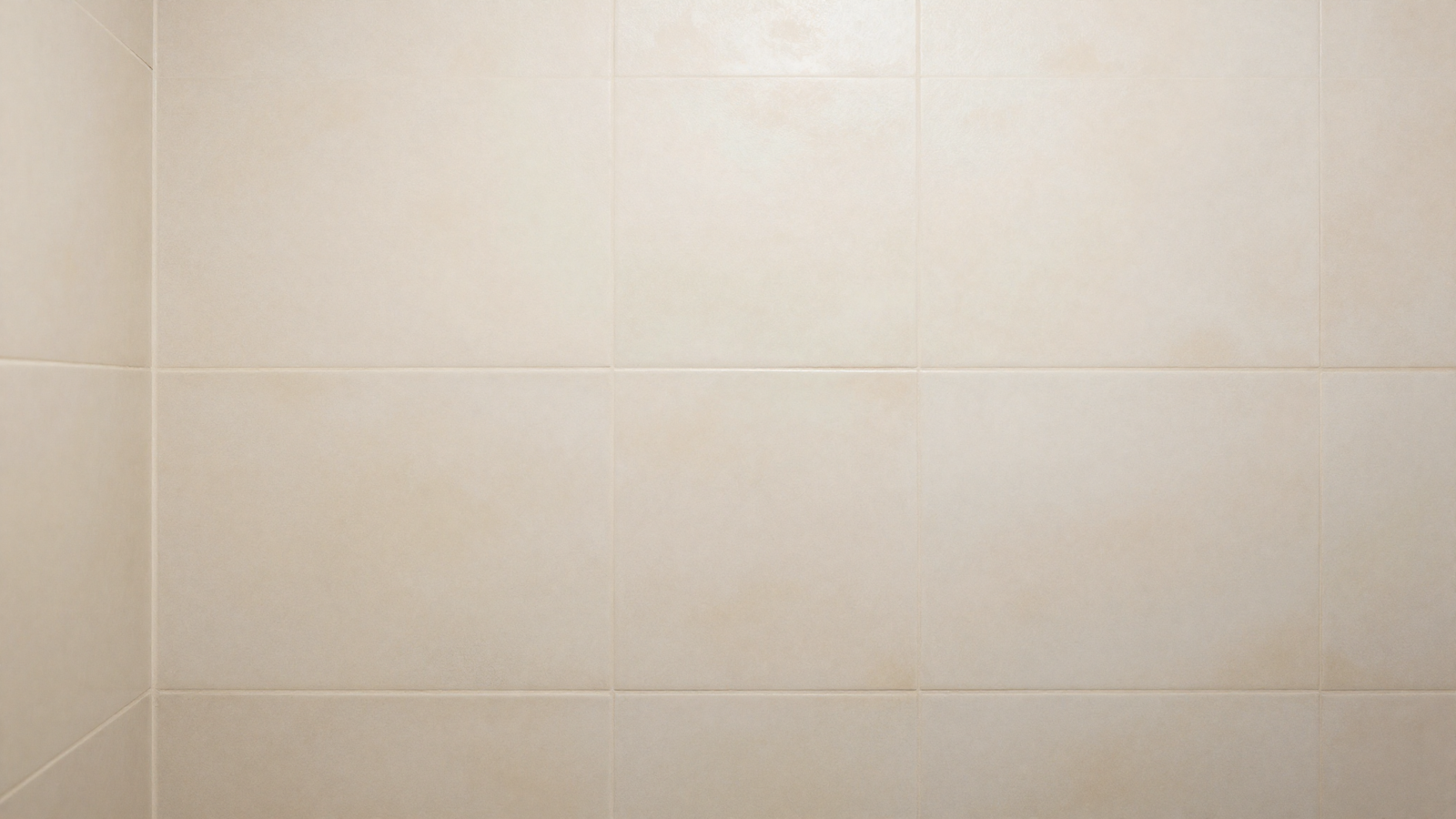 Bathroom shower wall with limewash-effect porcelain tile mimicking Venetian plaster texture