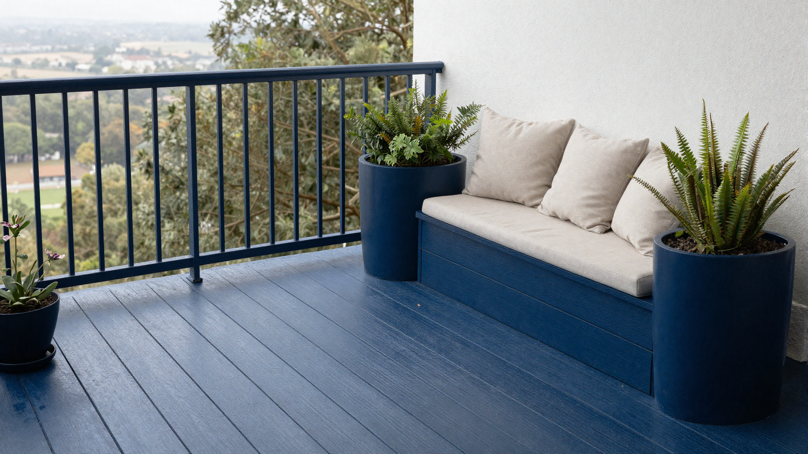 Balcony with navy blue painted wood floor tiles and matching navy planters