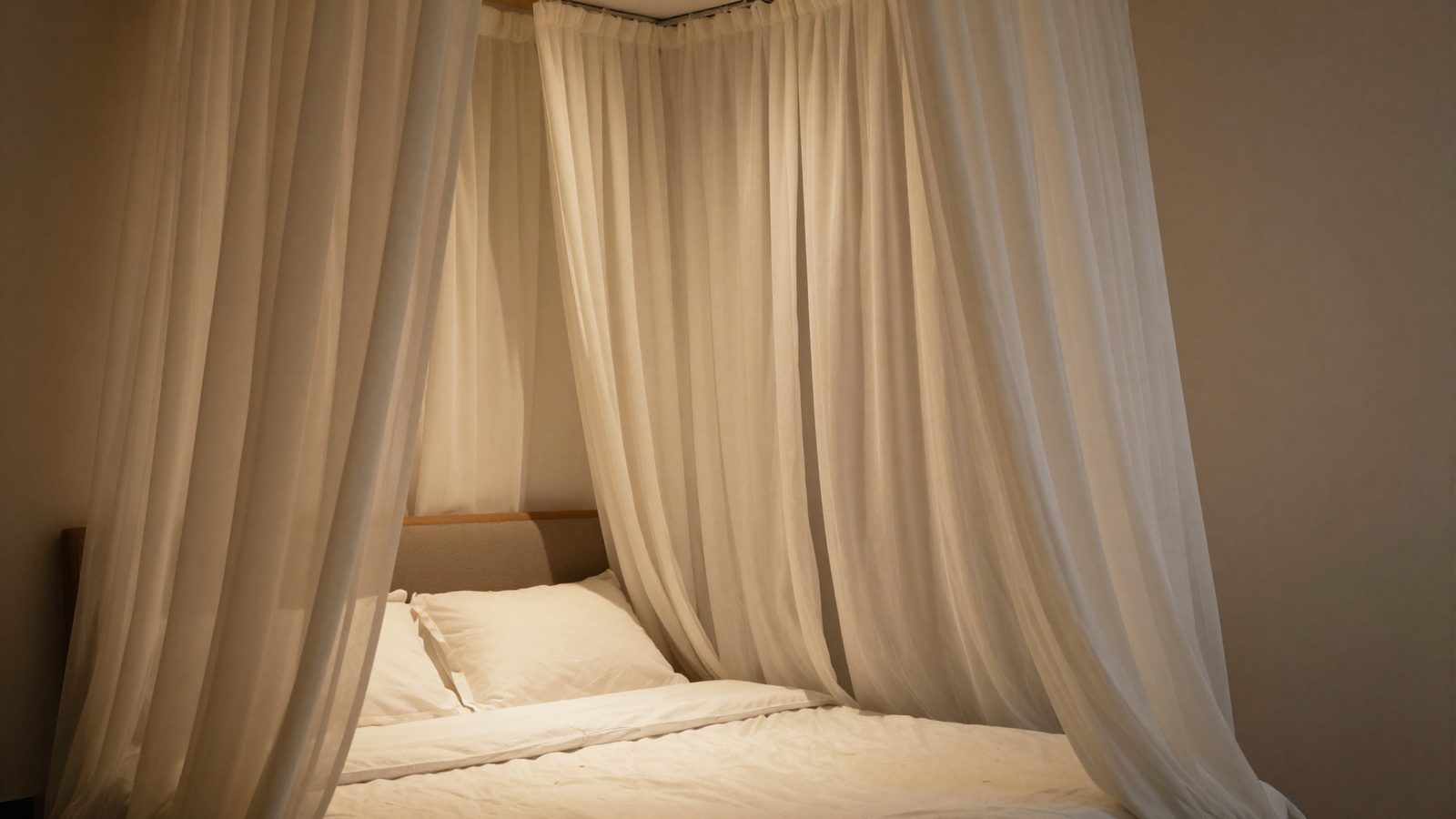 Bedroom with decorative interior drapes hung indoors around the bed adding intimacy
