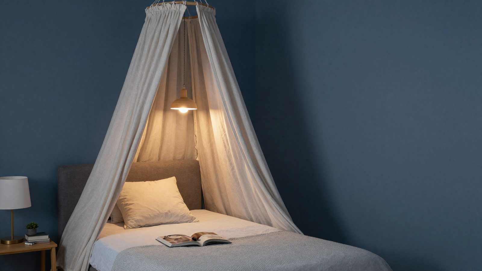 Bedroom reading nook with dusty midnight blue accent wall behind the headboard