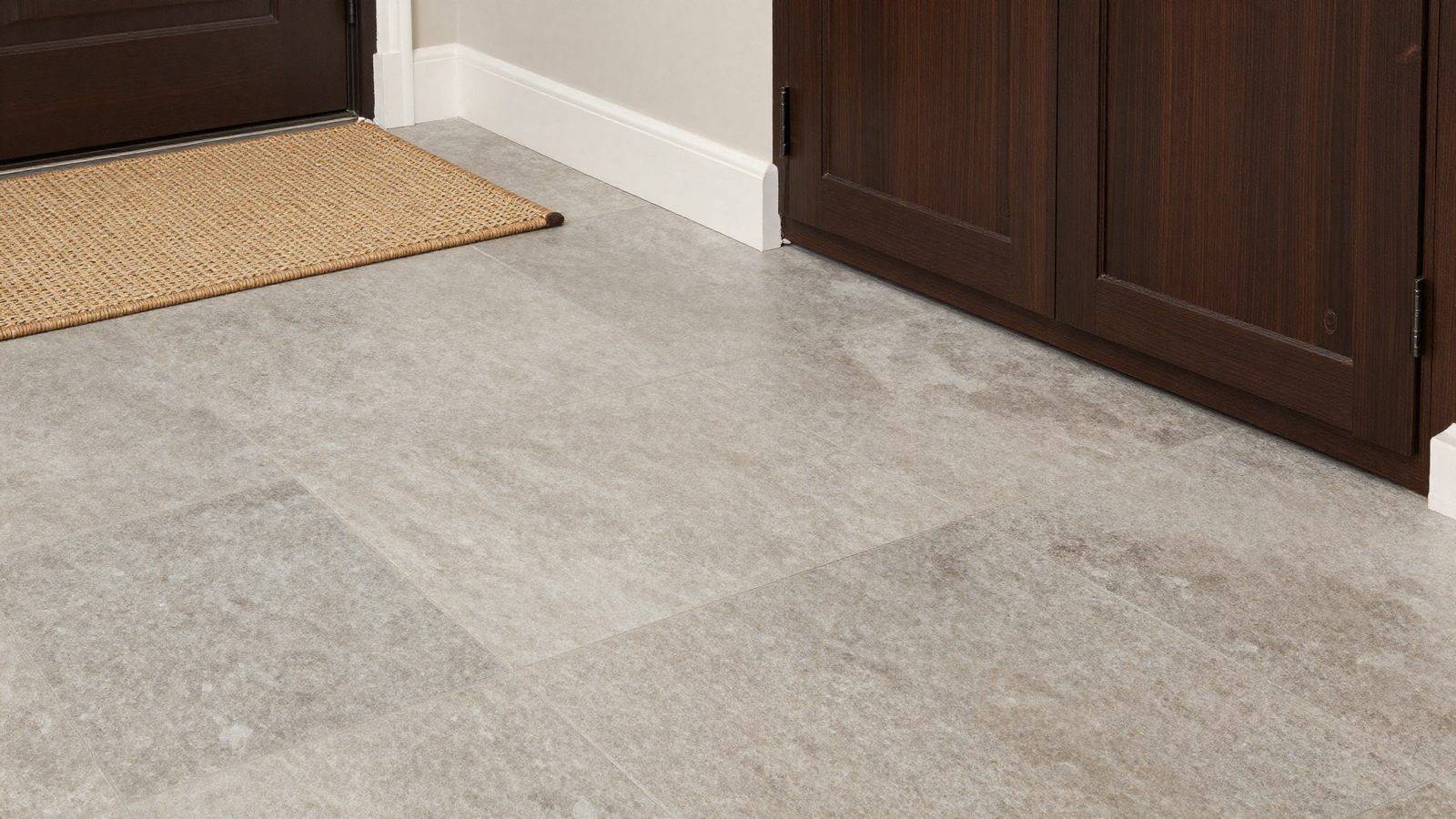 Mudroom floor with durable stone-look tile and woven runner rug