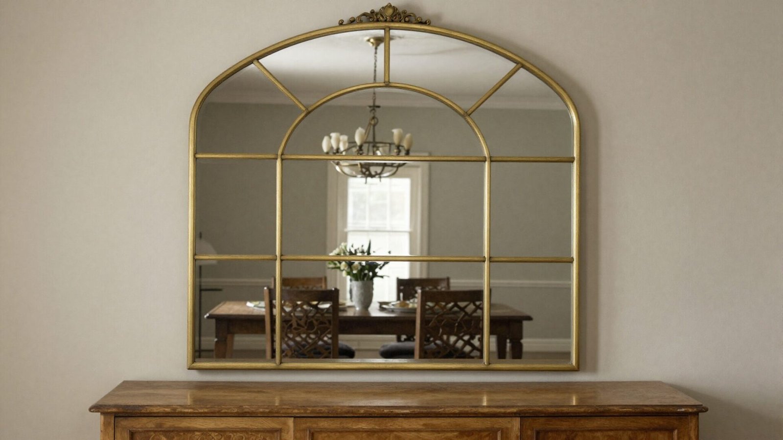 Dining room sideboard with a large statement arched mirror above it