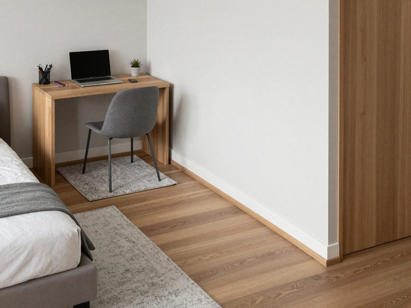 Separate rug under a desk zone distinct from the rug placed under the bed