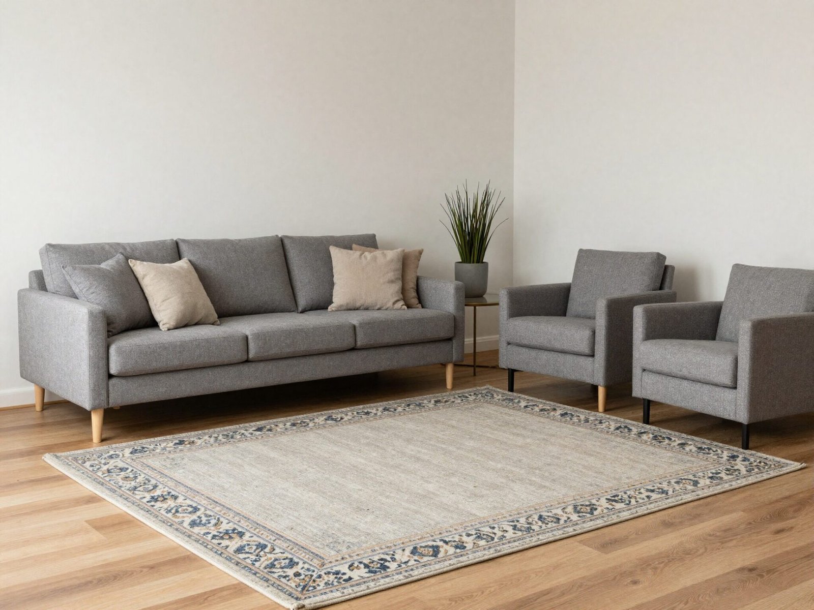 Sofa and two chairs arranged around an 8 by 10 foot rug