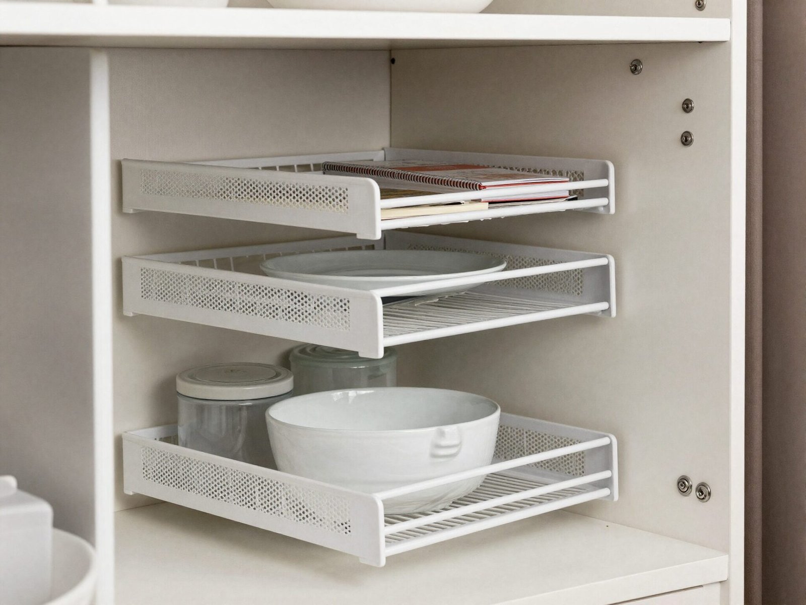 Deep pantry shelf with a tiered riser organizer keeping items in the back visible