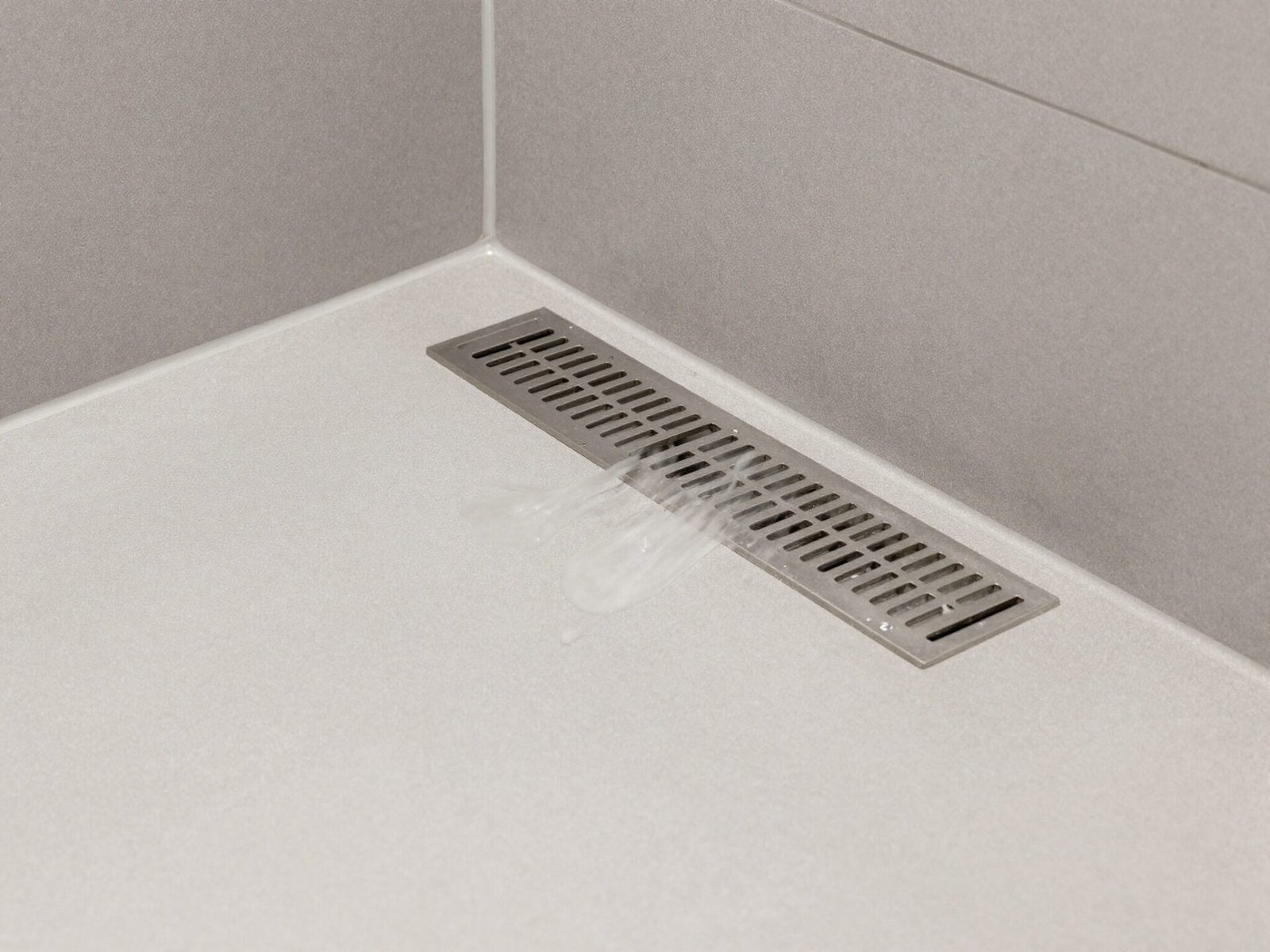 Shower floor with a linear drain and sloped tile for water flow