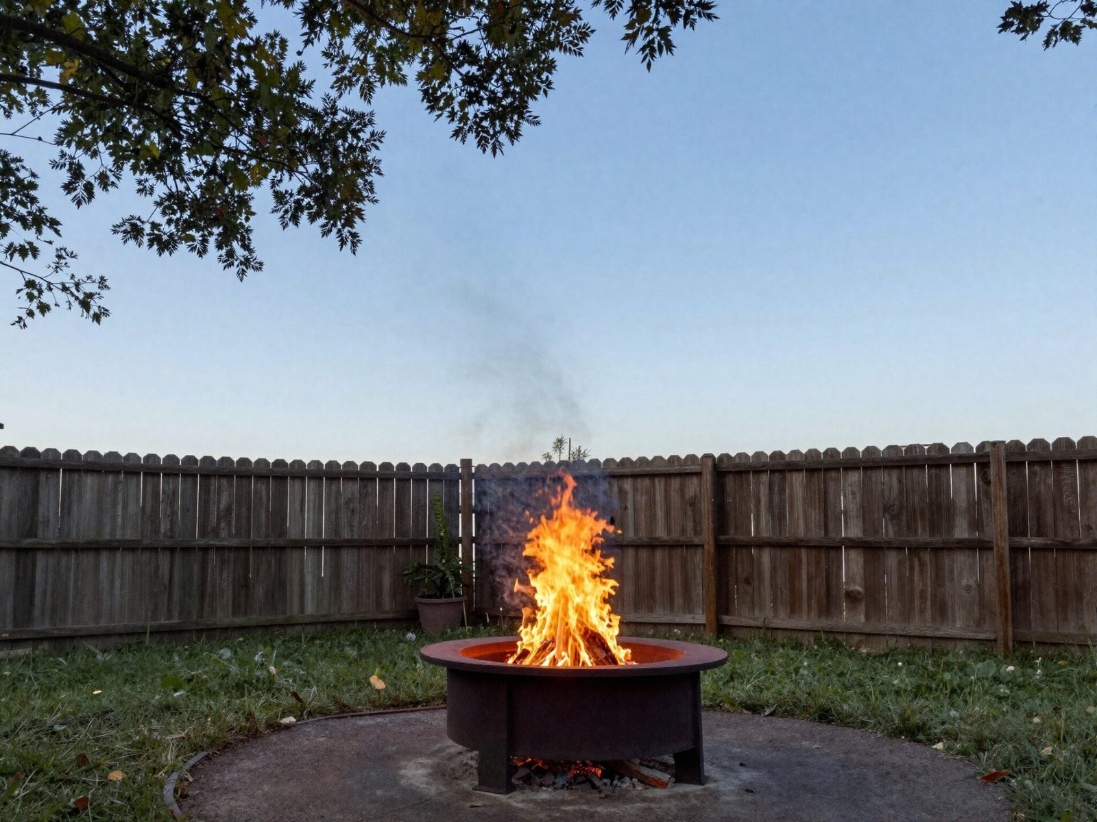 Backyard fire pit with open sky and no overhanging branches above it