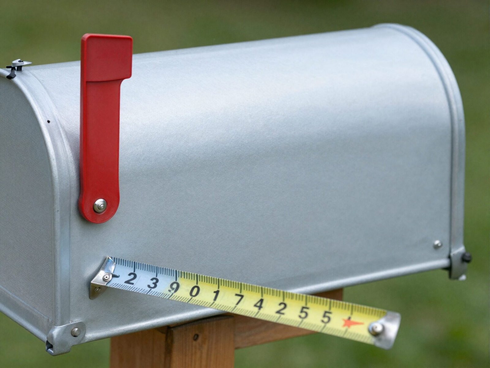 Mailbox with a tape measure showing its length and width