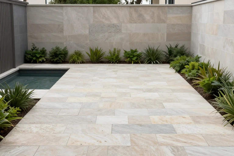Pale limestone pavers laid out in a small garden area.
