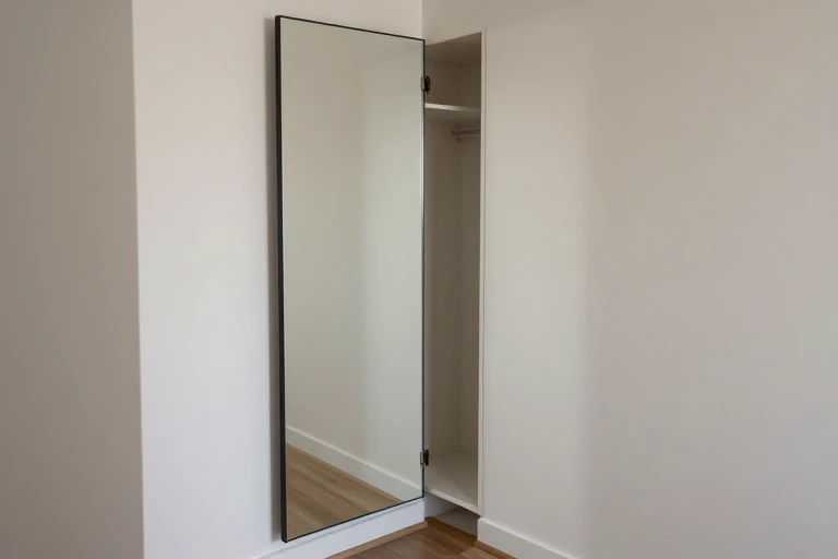 A hallway mirror that swings open to reveal a concealed storage compartment.