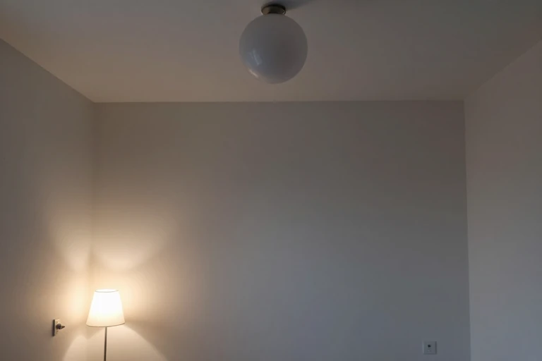 Dark bedroom illuminated by separate ambient, reading, and accent lights