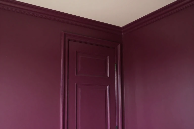 Aubergine walls, door, and trim with a contrasting ivory ceiling