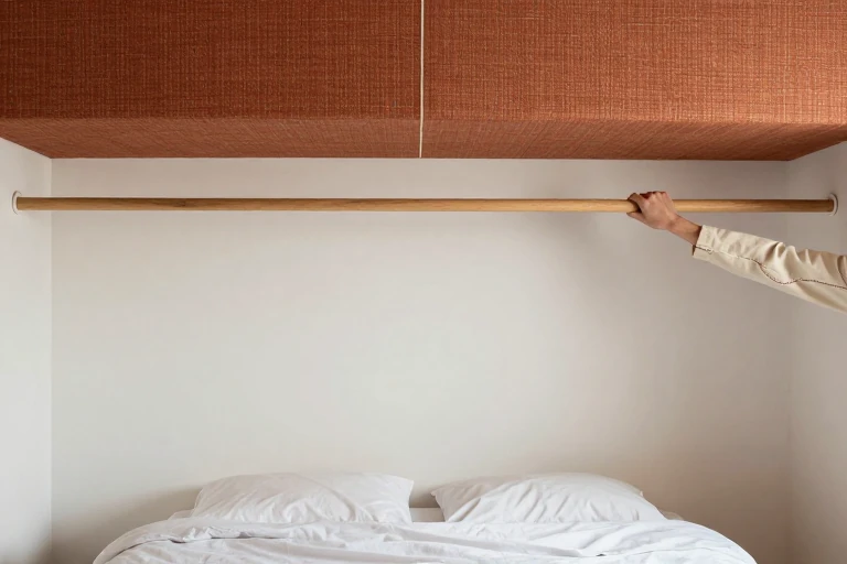 Large woven textile mounted above a low bed
